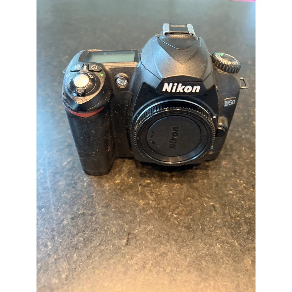 Nikon D50 DSLR camera with accessories charger, strap, cables, manual lens